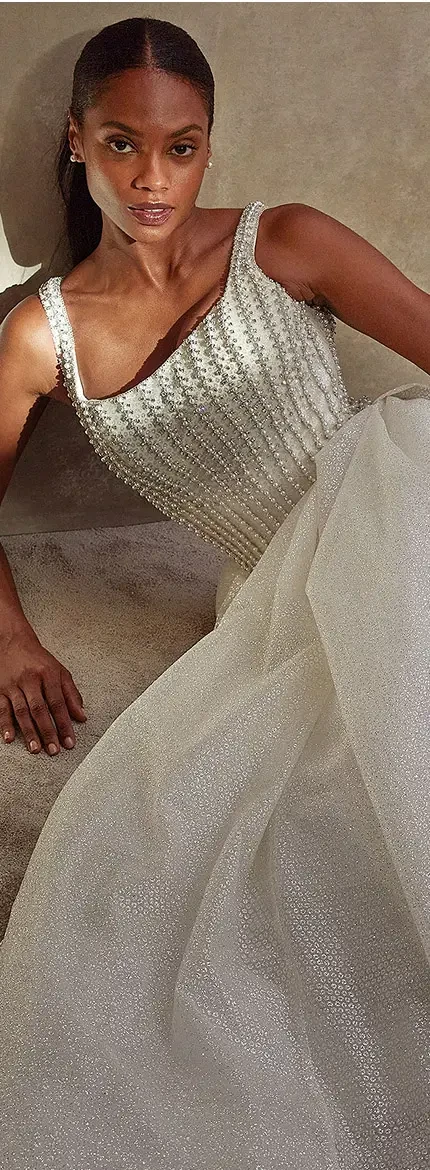 Model wearing a white gown and posing
